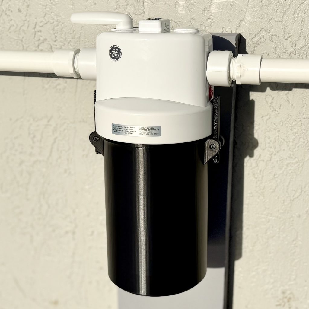 Fitted black cover on a whole-house filter housing