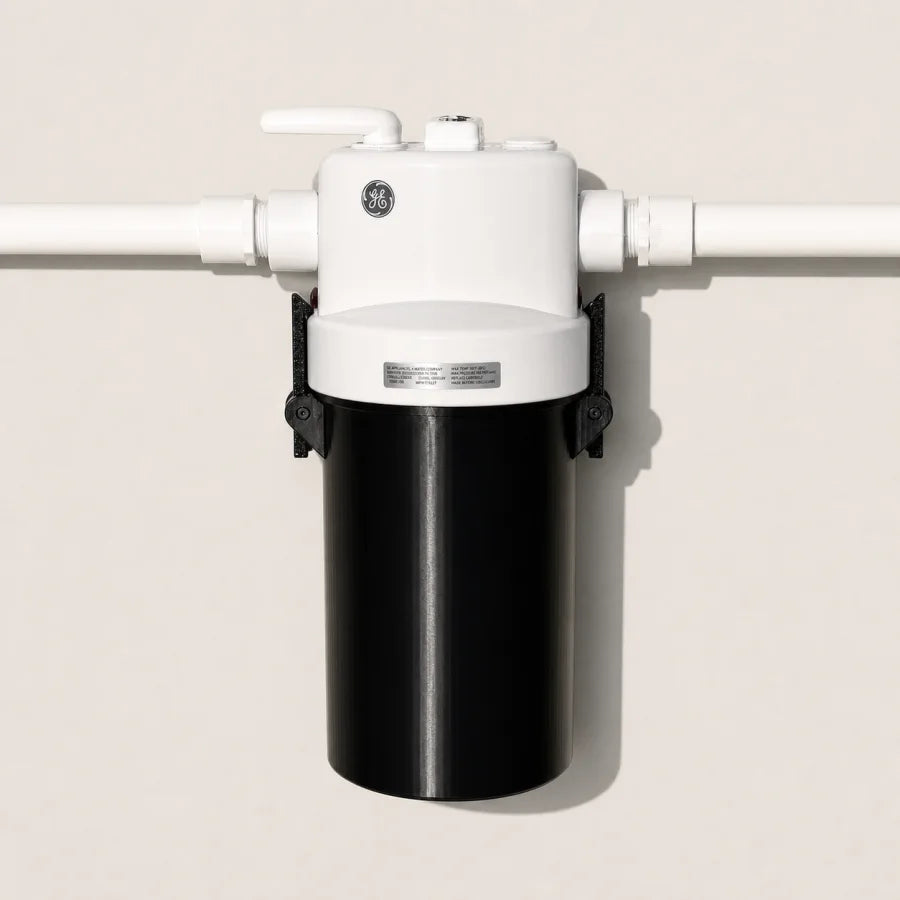 Fitted black cover on a GE GXWH40L water filter housing